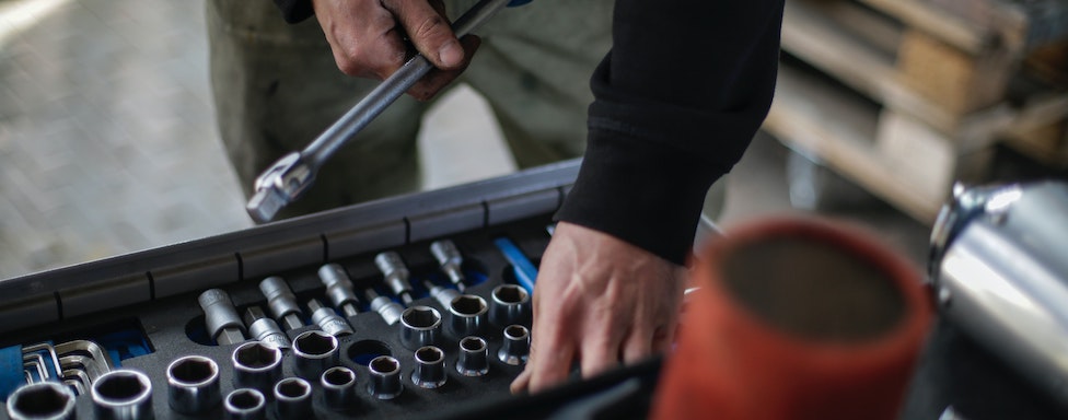 Mechanic choosing a tool in a repair shop